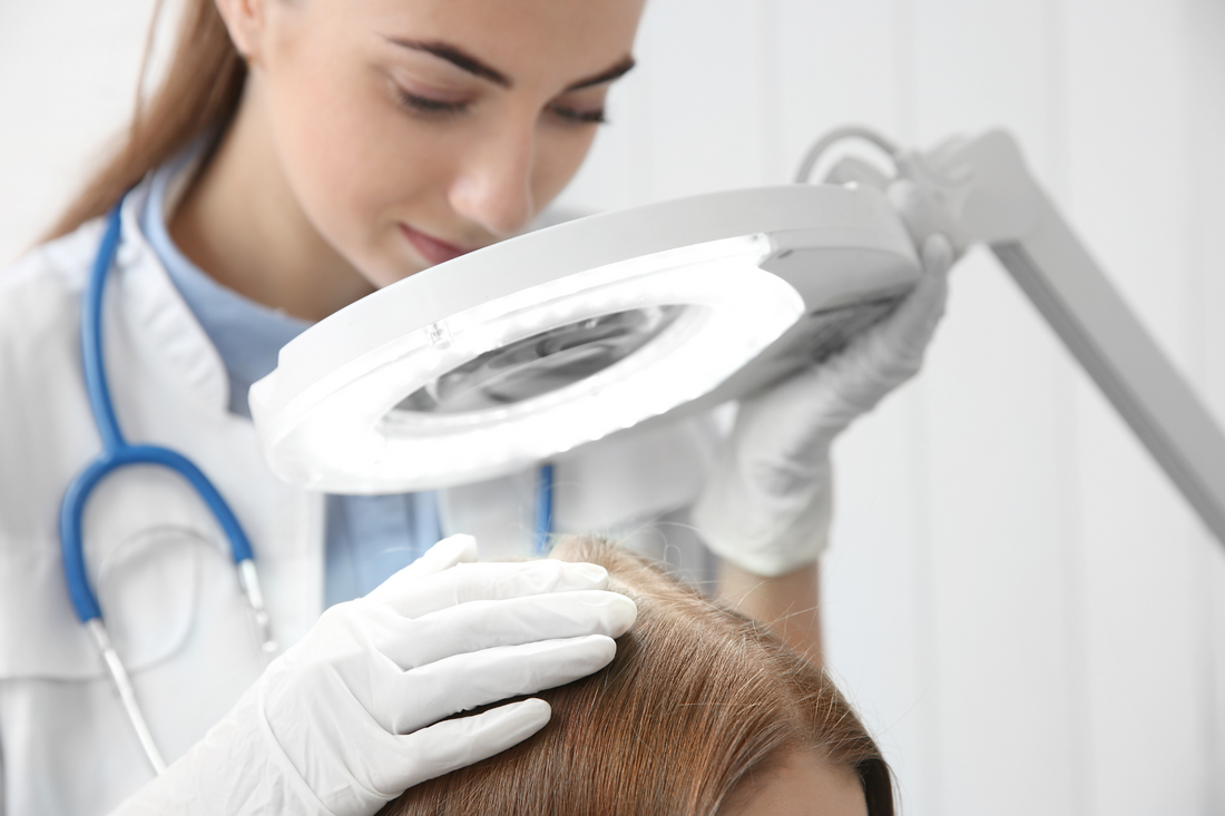 trichologist inspects hair of patient